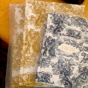 Three Dior notebooks